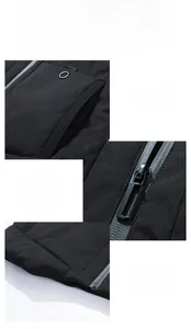 Detail view of windproof zipper, utility pocket with ring, and stitched hem on men's vest