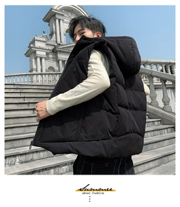 Close-up of black hooded puffer vest with horizontal quilting and durable polyester fabric