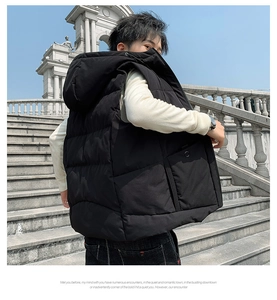 Detail view of black hooded padded vest featuring large side pockets and quilted design