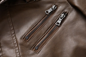 Detailed close-up of premium brown PU leather jacket featuring parallel metal zippers