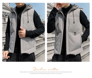 Detail view of men's grey puffer vest with hood, adjustable drawstrings and zip closure