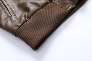 Macro detail of brown leather jacket with ribbed hem and high-quality stitching texture