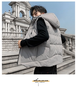 Detailed close-up of a gray quilted hooded puffer vest with matte fabric and horizontal stitching