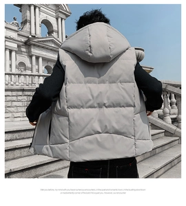 Detailed close-up of grey quilted puffer vest showing fabric texture and padded hood
