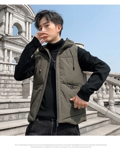 Detail view of olive green quilted puffer vest featuring an adjustable hood and zipper