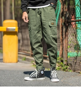 Detailed view of cargo pants featuring side flap pockets and military drawstring waist
