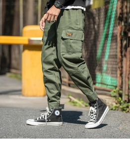 Detail of army green cargo pants featuring a Rankone pocket label and elastic ankle cuffs