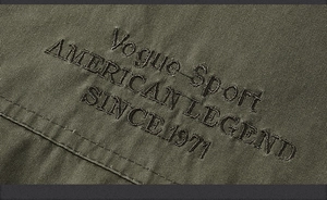 Detail of army green cotton vest fabric with Vogue Sport American Legend embroidery