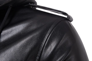 Close-up detail of black leather jacket shoulder with epaulettes and hood drawstrings