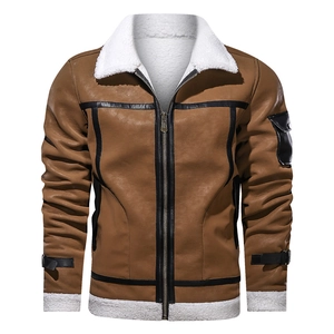 Detail of caramel brown shearling jacket with warm white faux fur collar and black trim