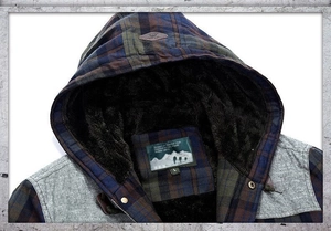 Detail of blue and brown plaid hooded shirt featuring warm brown faux fur lining and drawstring
