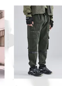 Detail of army green cargo pants with multi-pockets and fashion ribbon at the knee