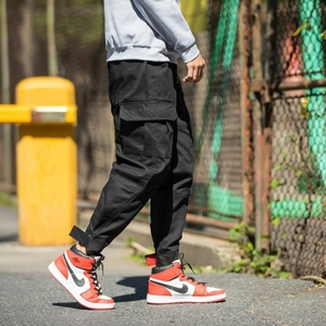 Men's black cargo joggers with side flap pockets and adjustable cuffs in street style