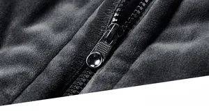 Close-up of durable metal zipper on men's winter vest with velvet fabric texture