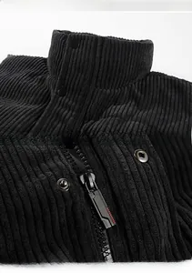 Detail view of black corduroy vest featuring a stand collar and metal zipper closure