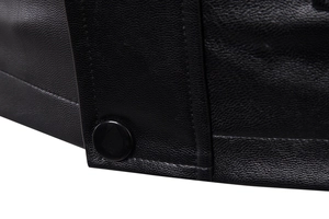 Close-up of black leather jacket details showing fine stitching and glossy button textures