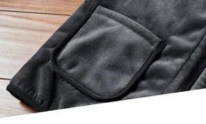 Macro detail of a grey fleece vest showing a patch pocket with hem and zipper teeth