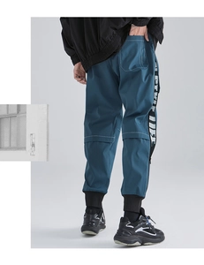 Detail of cargo pants showing contrast stitching, side tape, and elastic ankle cuffs