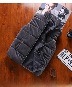 Close-up of dark grey quilted velvet vest featuring a stand collar and smooth zipper