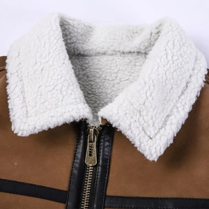 Detail of shearling collar and bronze metal zipper on a brown suede leather jacket