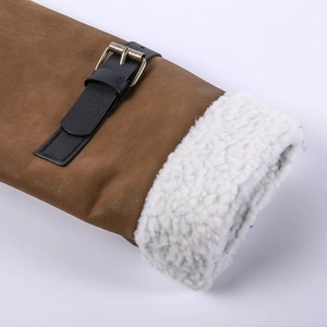 Detail of jacket cuff with brown leather strap, bronze buckle and white faux shearling lining