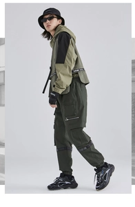 Men's urban techwear outfit with patchwork hoodie and multi-pocket green cargo pants