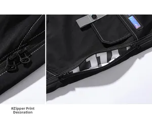 Detail of cargo pants showing double zippers, grey strap, and novel brand label design