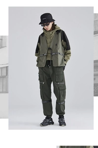 Detail of olive green techwear tactical vest and cargo pants with fashion straps