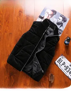 Flat lay of a black quilted velvet winter vest with a stand collar and zip-up closure