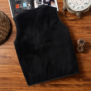 Men's winter fleece vest in black shown from the back on a warm wooden floor