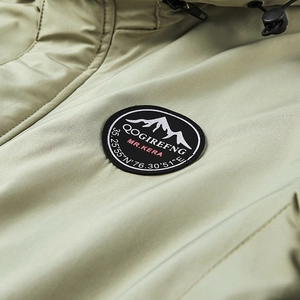 Olive green military tactical jacket featuring a detailed mountain emblem and quilted fabric