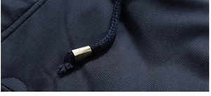 Detail of navy blue winter jacket with high-density fabric and metal-tipped drawstring