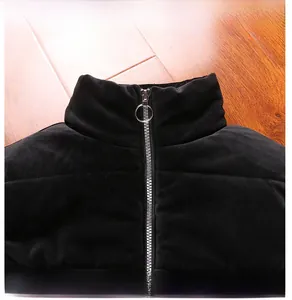Detail of stylish stand collar on men's black velvet vest with ring zipper puller