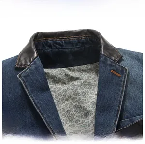 Close-up of denim jacket collar with leather trim and paisley pattern lining