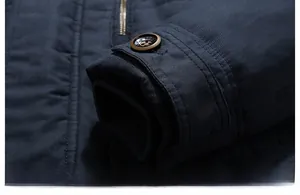 Detailed macro view of the navy blue jacket with ribbed windproof cuffs and buttoned straps