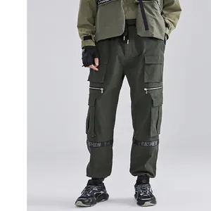 Men's dark green cargo pants with multi-pockets, functional straps, and jogger cuffs