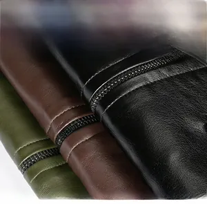 Detailed view of motorcycle leather jacket texture with zipper design and fabric label