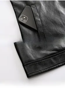 Detail of black faux leather jacket showing side pockets and premium lychee grain texture