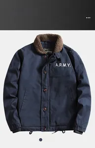 Detail of navy blue winter bomber jacket with brown sherpa collar and ARMY print