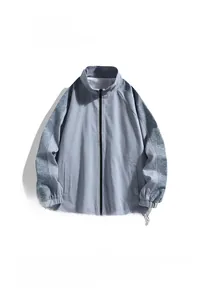 Detail of light blue casual jacket with paisley pattern sleeves and drawstring hem