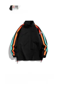 Detail of black sports jacket featuring vibrant orange and teal side stripes and elastic cuffs