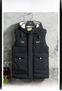 Detail of hooded down puffer vest with zipper, large pockets and TME DAE lettering