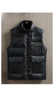 Detail of black down vest featuring standing collar and chest pocket with WERE lettering