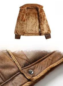 Detail of faux leather bomber jacket showing thick shearling lining and metal hem buckles