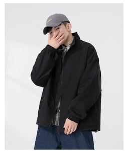 Detail of black men's casual zip-up jacket with stand collar and raglan sleeve design