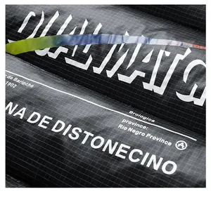 Detail of black ripstop puffer vest showing white graphic print and gradient decorative tape