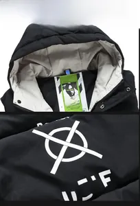 Detail of hooded neckline with interior tag and white graphic print on black padded vest