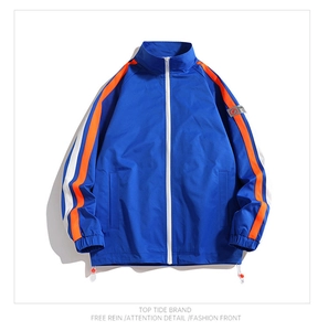 Detail of navy sport jacket with orange striped sleeves and white zipper closure