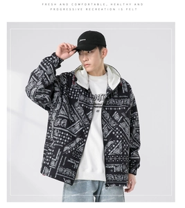 Close-up of men's paisley hooded jacket styled with white sweatshirt and denim jeans