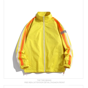 Detail view of yellow stand-collar jacket with sporty sleeve stripes and drawstring hem